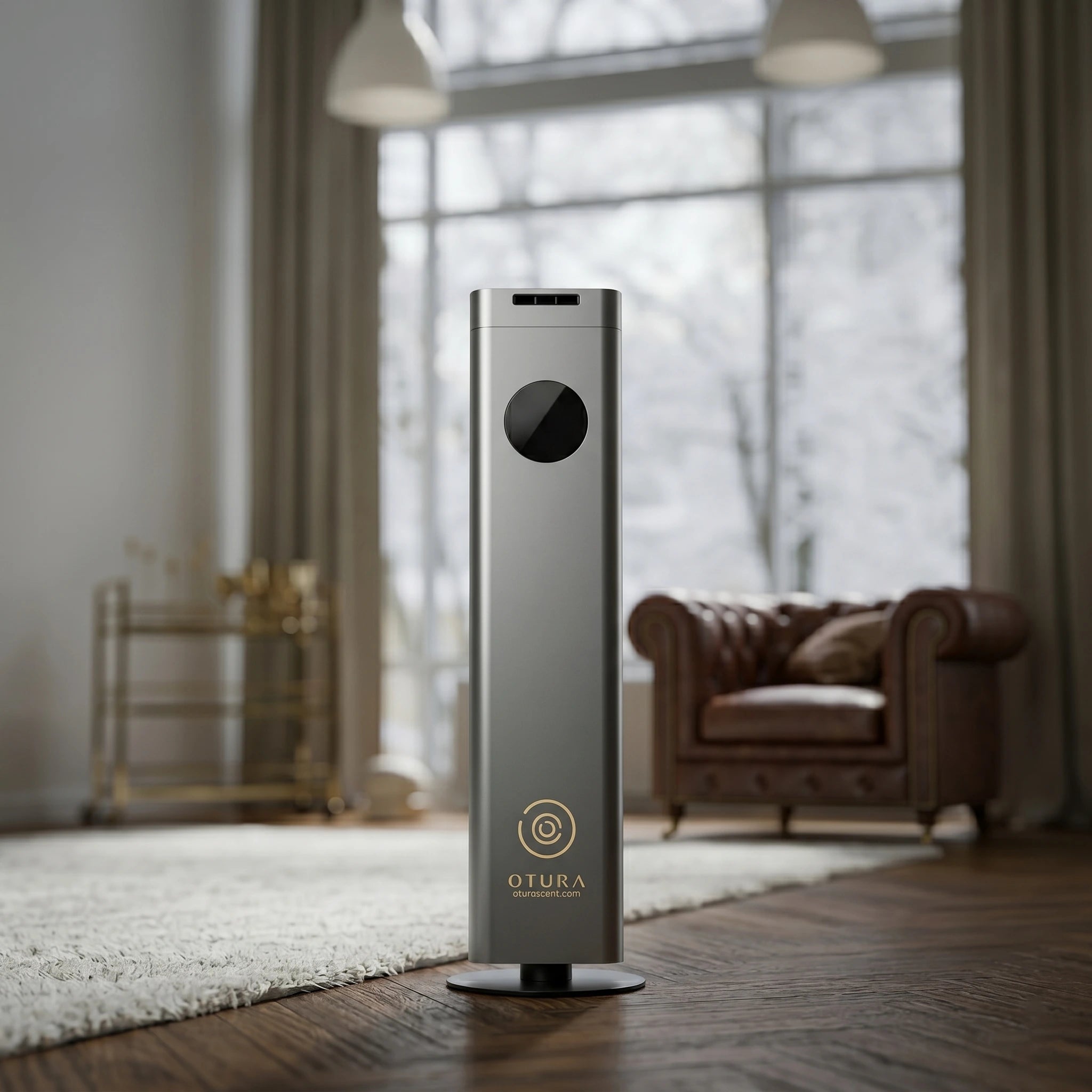 Otura Essence Modern air purifier in a living room setting with large windows and a brown leather sofa.